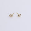 Gold bezel stud earrings on neutral background