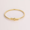 Video of gold bracelet on white background.