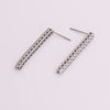 Video of tennis earrings on white background.