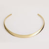 Video of a gold collar necklace on white background.
