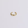 Gold ear cuff on neutral background