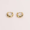 Video of gold hoop earrings on white background.