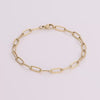Video of gold chain bracelet on white background.