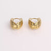 Video of gold hoop earrings on white background.