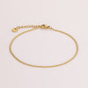 Video of gold chain anklet on white background.