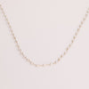 Video of a pearl chain necklace on white background.